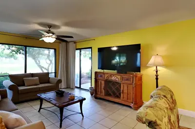 a living room with a couch and a tv at Edgewater Villa #2003 in Panama City Beach