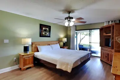 a bedroom with a bed and a ceiling fan at Edgewater Villa #2003 in Panama City Beach