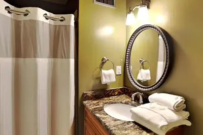 a bathroom with a sink and a shower and a mirror at Edgewater Villa #2003 in Panama City Beach