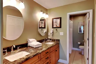 a bathroom with two sinks and a large mirror at Edgewater Villa #2003 in Panama City Beach