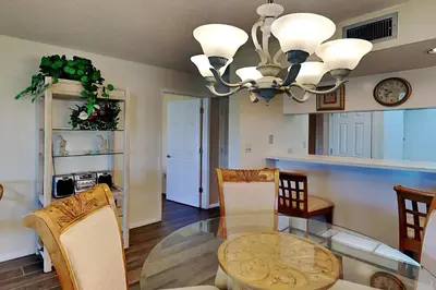 a dining room with a glass table and chairs at Edgewater Villa #2011 in Panama City Beach