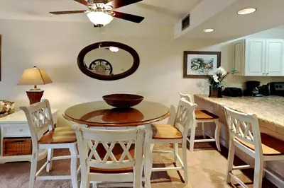a kitchen and dining room with a table and chairs at Edgewater Villa #2209 in Panama City Beach