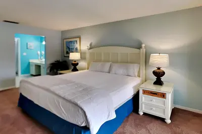 a bedroom with a large white bed with two lamps at Edgewater Villa #2209 in Panama City Beach