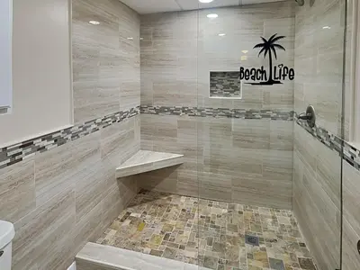 a bathroom with a walk in shower with a sink at Edgewater Tower I #207 in Panama City Beach