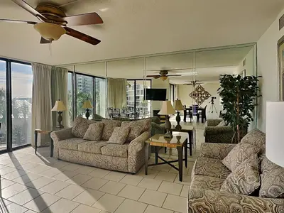 a living room with two couches and a ceiling fan at Edgewater Tower I 211 in Panama City Beach
