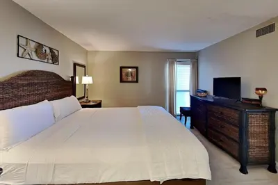 a bedroom with a large bed and a television at Edgewater Tower I 406 in Panama City Beach