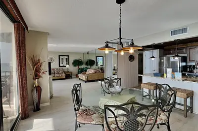 a kitchen and living room with a table and chairs at Edgewater Tower I 406 in Panama City Beach