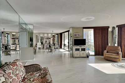 a living room with a couch and a tv in a room at Edgewater Tower I 406 in Panama City Beach