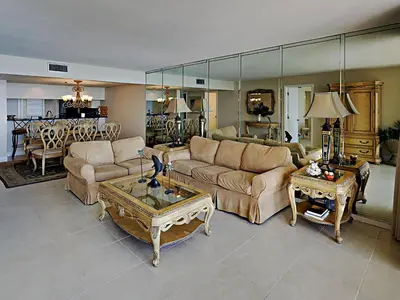 a living room with two couches and a table at Edgewater Tower I 610 in Panama City Beach