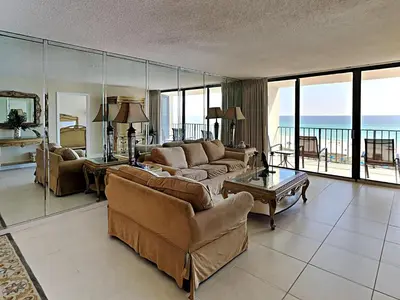 a living room with couches and a view of the ocean at Edgewater Tower I 610 in Panama City Beach