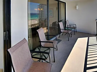 a row of chairs and tables on a balcony at Edgewater Tower I 806 in Panama City Beach