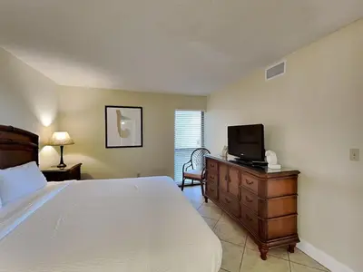 a bedroom with a bed and a television on a dresser at Edgewater Tower I 806 in Panama City Beach
