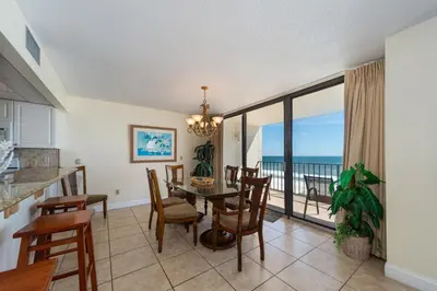 a dining room with a table and a view of the ocean at Edgewater Tower I 806 in Panama City Beach