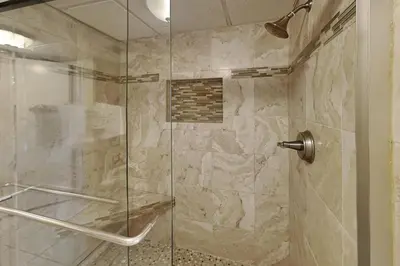 a bathroom with a shower with a glass door at Edgewater Tower II 912 in Panama City Beach
