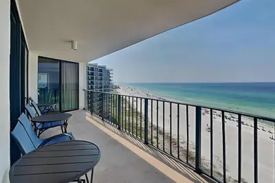 a balcony with chairs and a view of the beach at Edgewater Tower II 912 in Panama City Beach