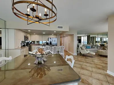 a kitchen and dining room with a table and a chandelier at Edgewater Tower II 1001 in Panama City Beach