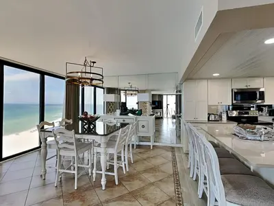 a kitchen and dining room with a table and chairs at Edgewater Tower II 1001 in Panama City Beach