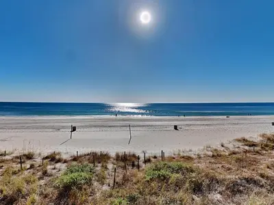 a beach with the ocean and the moon in the sky at Edgewater Tower III 114 in Panama City Beach