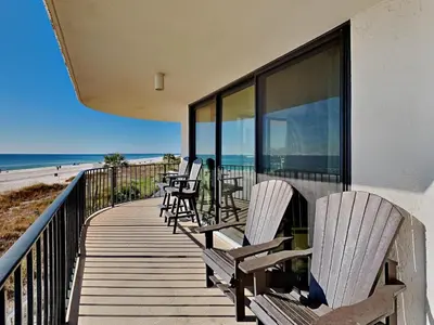 a wooden deck with chairs and the beach at Edgewater Tower III 114 in Panama City Beach