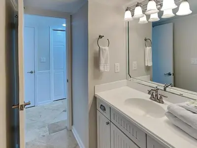 a bathroom with a sink and a mirror at Edgewater Tower III #501 in Panama City Beach