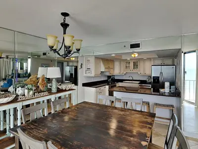 a large kitchen with a wooden table and chairs at Edgewater Tower III #501 in Panama City Beach
