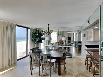 a kitchen and dining room with a table and chairs at Edgewater Tower III #501 in Panama City Beach