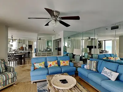 a living room with blue couches and a ceiling fan at Edgewater Tower III #501 in Panama City Beach