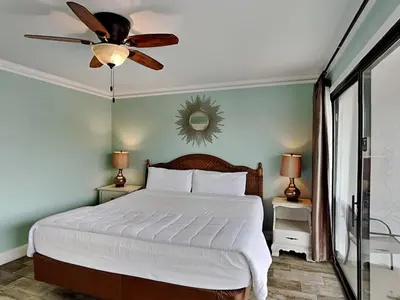 a bedroom with a bed and a ceiling fan at Edgewater Villa 1216 in Panama City Beach