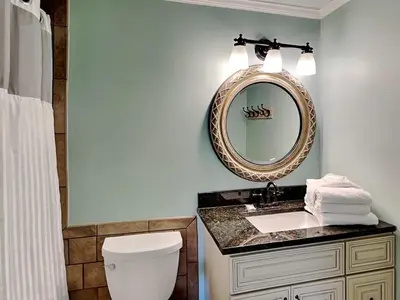 a bathroom with a sink and a mirror at Edgewater Villa 1216 in Panama City Beach