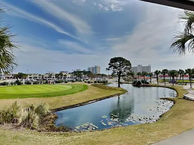a view of a golf course with a pond at Edgewater Villa 1216 in Panama City Beach