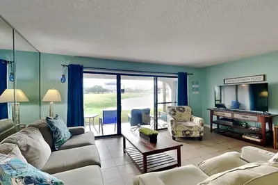 a living room with a couch and a table at Edgewater Villa 1501 in Panama City Beach