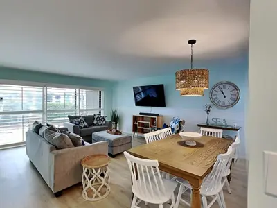 a living room with a table and a couch at Edgewater Villa #2505 in Panama City Beach