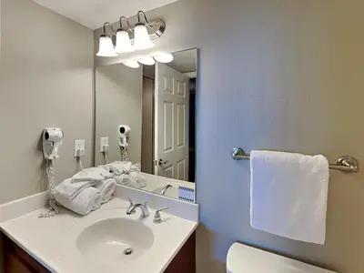 a bathroom with a sink and a mirror at Emerald Beach #2435 in Panama City Beach