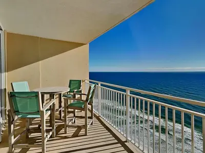 a balcony with a table and chairs and the ocean at Emerald Beach #2435 in Panama City Beach