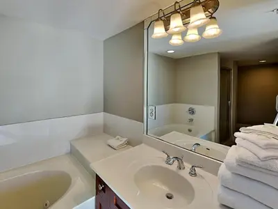 a bathroom with a sink and a large mirror at Emerald Beach #2435 in Panama City Beach