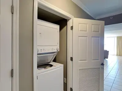 a kitchen with a washer and dryer in a closet at Emerald Beach #2435 in Panama City Beach