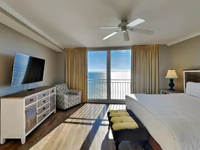 a bedroom with a large bed and a large window at Emerald Beach #2435 in Panama City Beach
