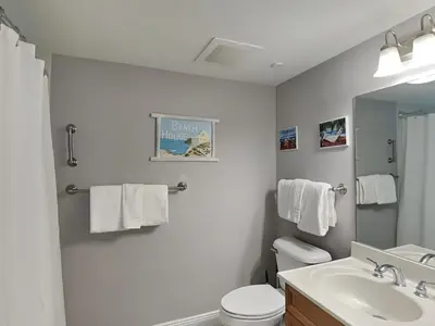 a bathroom with a sink and a toilet and a mirror at Emerald Beach #2535 in Panama City Beach