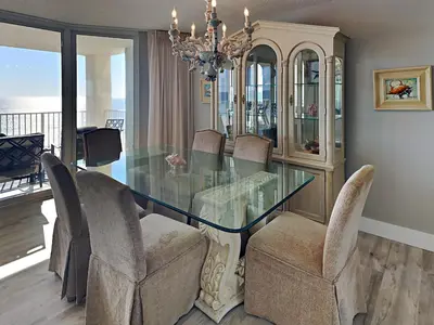 a dining room with a glass table and chairs at Long Beach Resort Tower I #506 in Panama City Beach