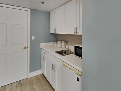 a kitchen with white cabinets and a sink at Long Beach Resort Tower I #506 in Panama City Beach