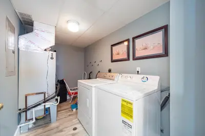 a laundry room with a washer and a refrigerator at Long Beach Resort Tower I #506 in Panama City Beach