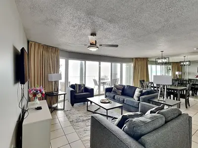 a living room with couches and a dining room at Long Beach Resort Tower II #306 in Panama City Beach
