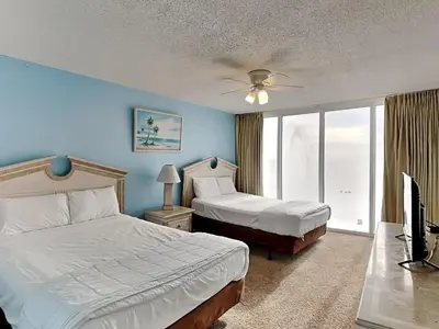 a bedroom with two beds and a flat screen tv at Long Beach Resort Tower II #306 in Panama City Beach