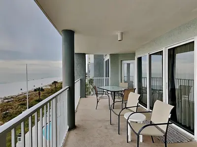 a balcony with a table and chairs and the ocean at Long Beach Resort Tower II #306 in Panama City Beach