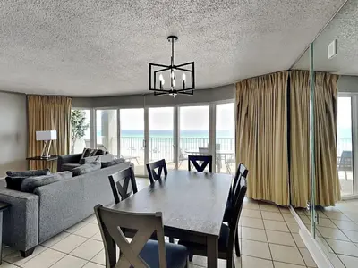a dining room with a table and a couch at Long Beach Resort Tower II #306 in Panama City Beach