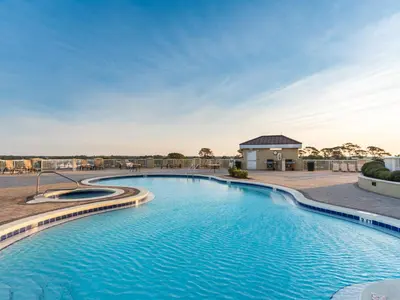 a pool at a resort with blue water at Grand Panama Beach Resort - The Grand #1304 in Panama City Beach