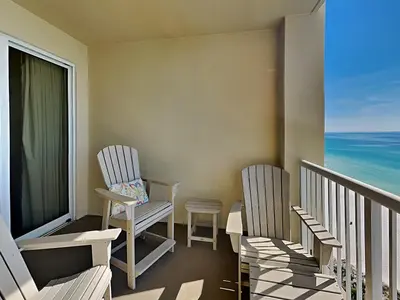 two chairs sitting on a balcony with the ocean at Grand Panama Beach Resort - The Grand #1304 in Panama City Beach
