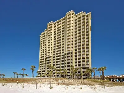 a large building on the beach next to the beach at Grand Panama Beach Resort - The Grand #403 in Panama City Beach