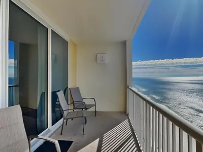 a balcony with chairs and a view of the ocean at Majestic Beach Towers I #2108 in Panama City Beach