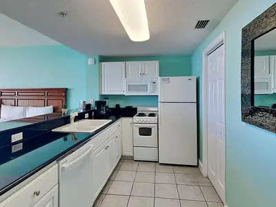 a kitchen with a white refrigerator and a sink at Majestic Beach Towers I #2108 in Panama City Beach
